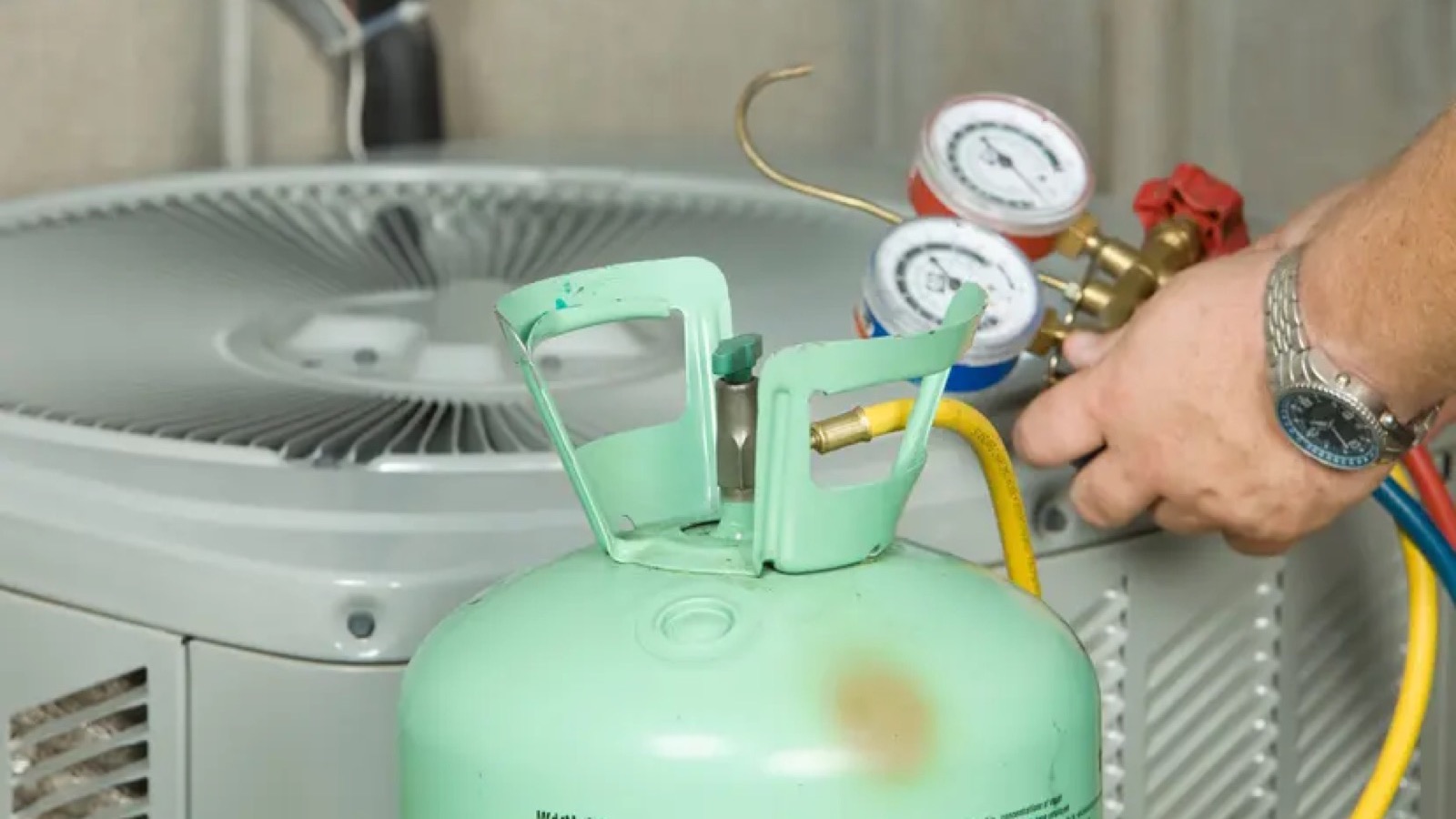 HVAC technician diagnosing an outdoor AC unit at a Gilbert home
